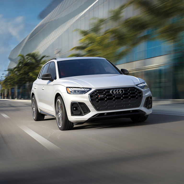 Elevated three-quarter front view of the Audi SQ5 accelerating. 